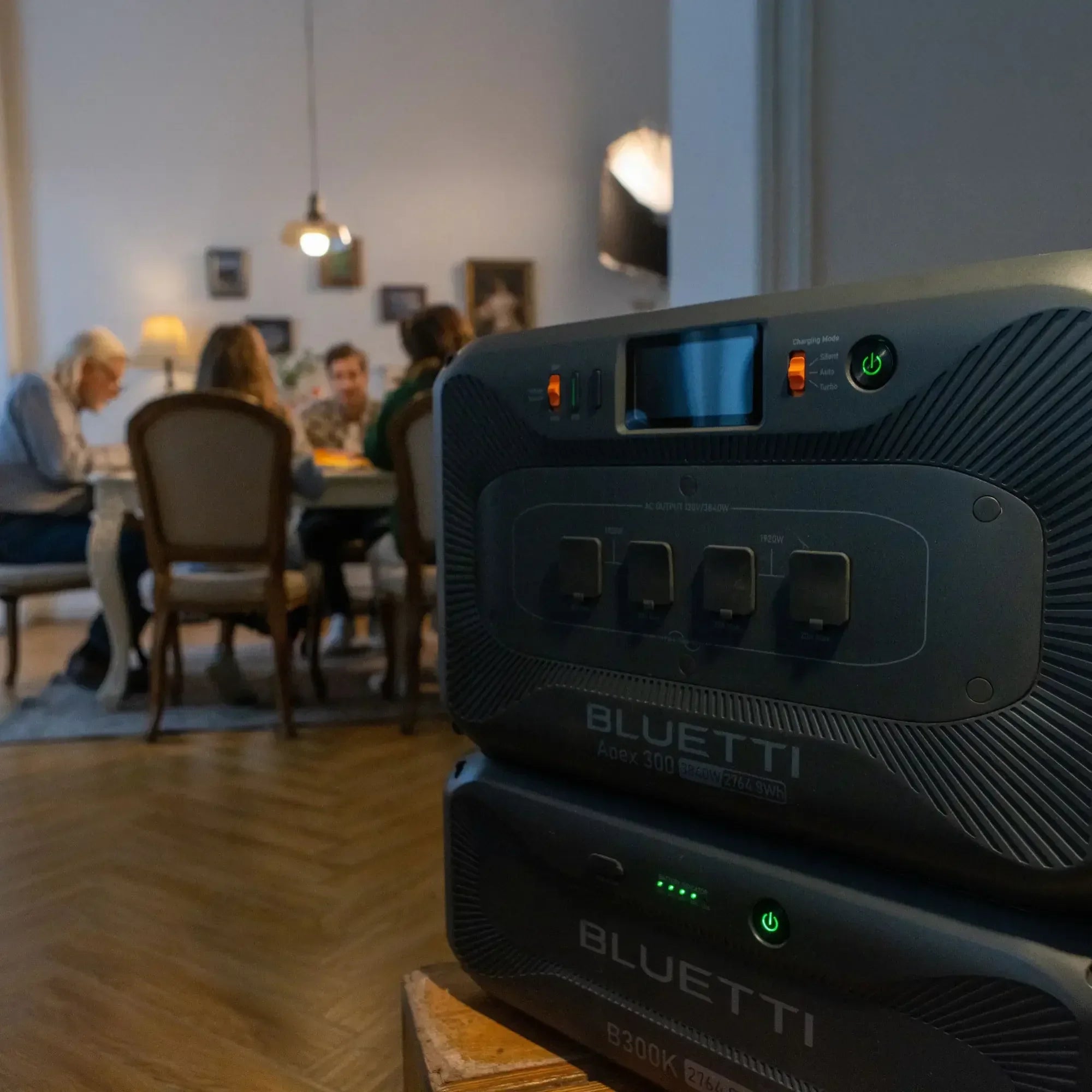Bluetti portable power stations in a cozy home with family dining in background