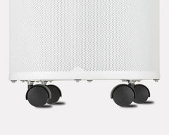 Set of four black caster wheels attached to a white perforated appliance base