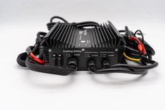 Black cranking battery charger with labeled ports, cables, and a finned heat sink design.