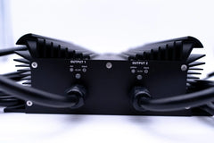 Inverter with dual outputs, heat sink fins, and labeled voltage ports, close-up view