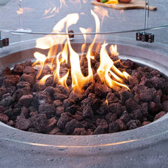 Elementi Metropolis fire pit table with lava rocks and flames, outdoor centerpiece