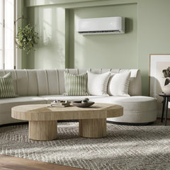 MRCOOL wall-mounted air conditioner in a modern living room with white sofa and wooden table