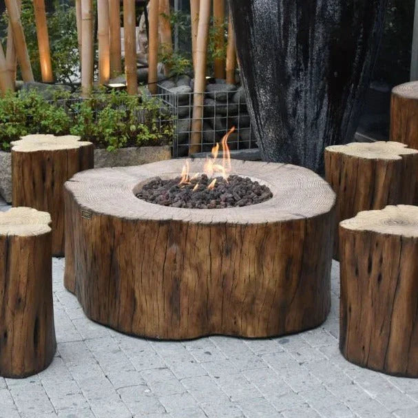 Manchester outdoor fire pit table set with tree trunk design and matching stools on patio