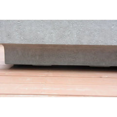 OFG104 base of concrete fire table on outdoor wooden deck, close-up view