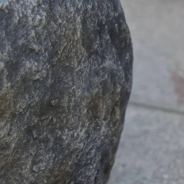 Elementi Boulder tank cover with realistic stone texture for outdoor use on patio