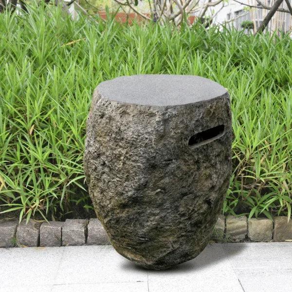 Elementi Boulder tank cover with stone texture in outdoor garden setting