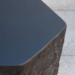 Elementi Columbia Seat close-up with textured stone and smooth black surface, outdoor accessory.
