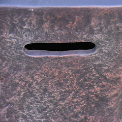 Elementi Columbia rust-textured metal seat detail with oval slot opening