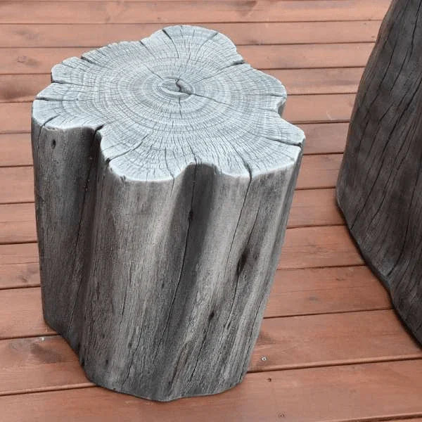 Elementi Warren seat in classic grey with wood grain texture on deck beside fire table