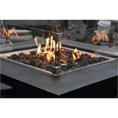 Elementi wind screen on fire pit table, close-up showing flames and glass shield