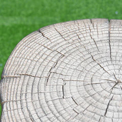 Manchester cast concrete tank cover with redwood texture, top left view on grass