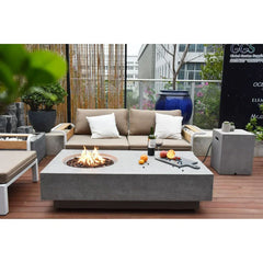 Modern outdoor patio with beige sofa, concrete fire pit table, wine and fruit display