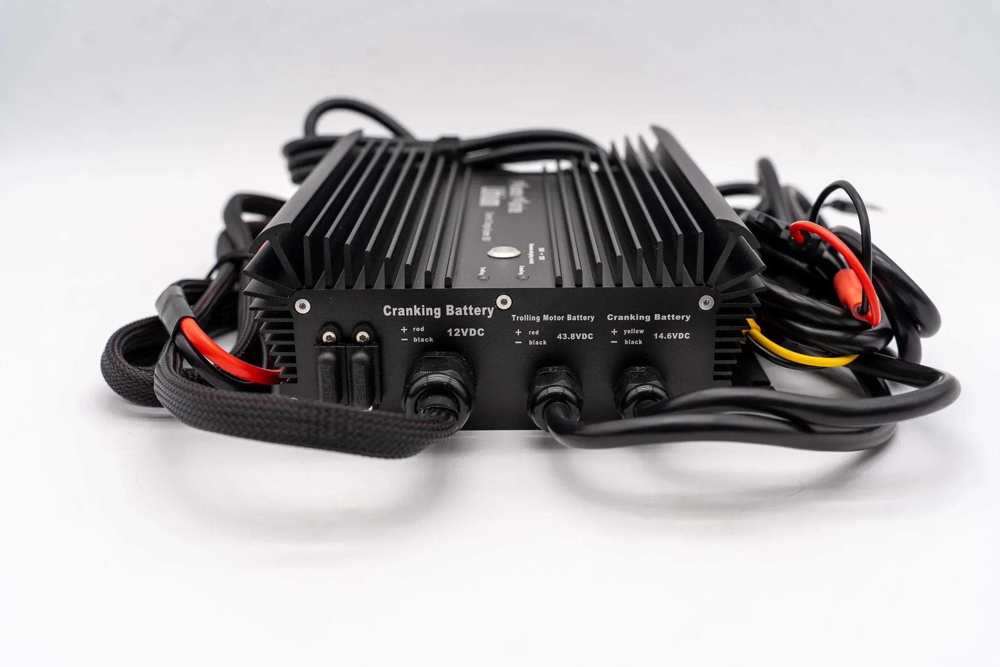 Black cranking battery charger with labeled ports, cables, and a finned heat sink design.